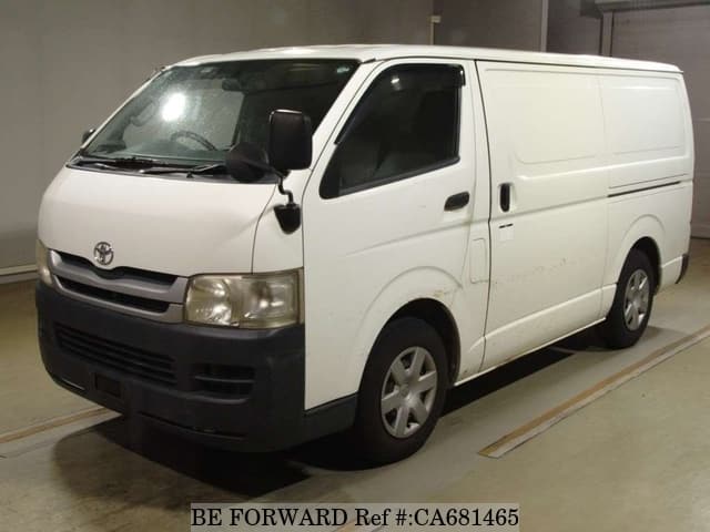 A grey JDM sports car speeding down a highway at night.