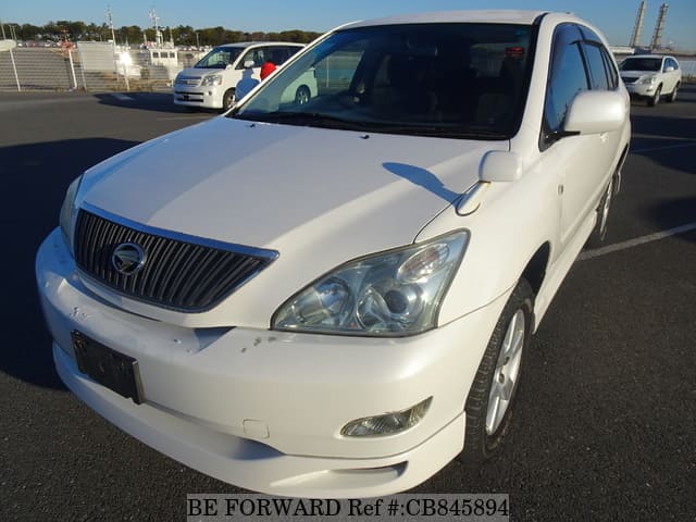 A grey JDM sports car speeding down a highway at night.
