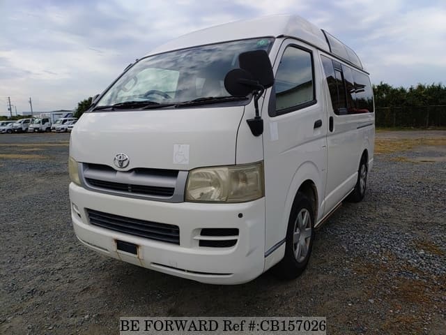 A grey JDM sports car speeding down a highway at night.
