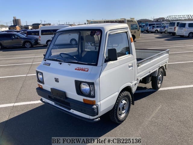 A grey JDM sports car speeding down a highway at night.
