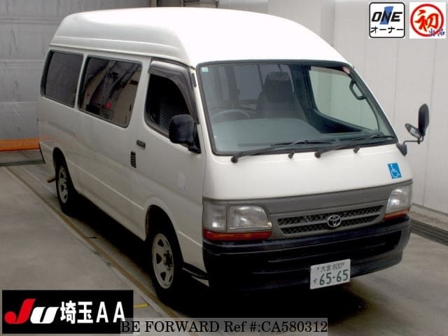 A grey JDM sports car speeding down a highway at night.