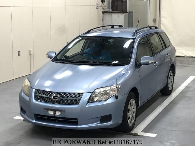 A grey JDM sports car speeding down a highway at night.