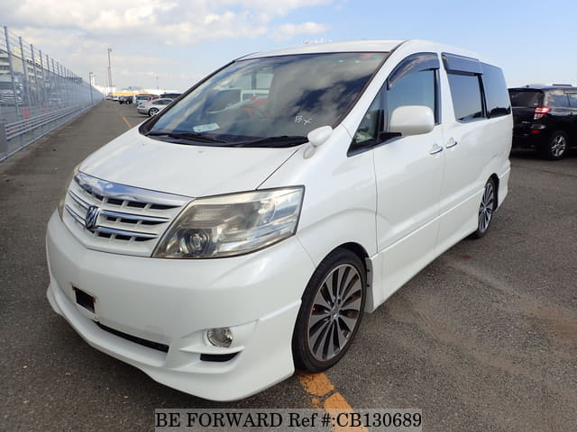 A grey JDM sports car speeding down a highway at night.