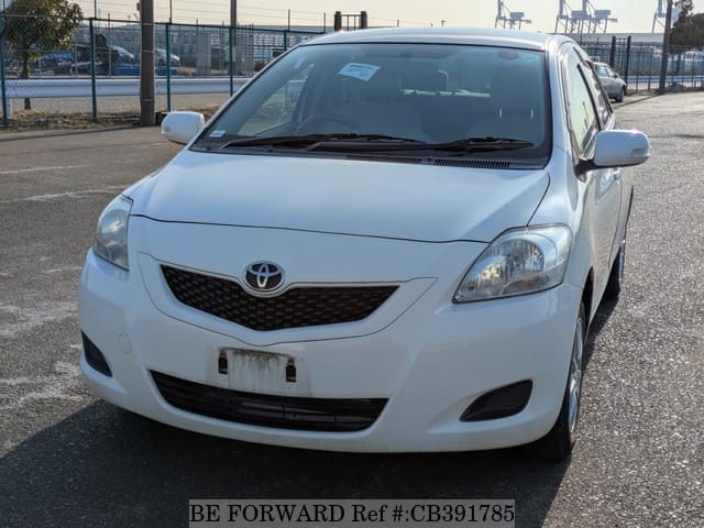 A grey JDM sports car speeding down a highway at night.