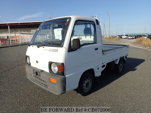 A grey JDM sports car speeding down a highway at night.