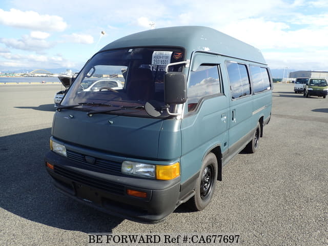 A grey JDM sports car speeding down a highway at night.
