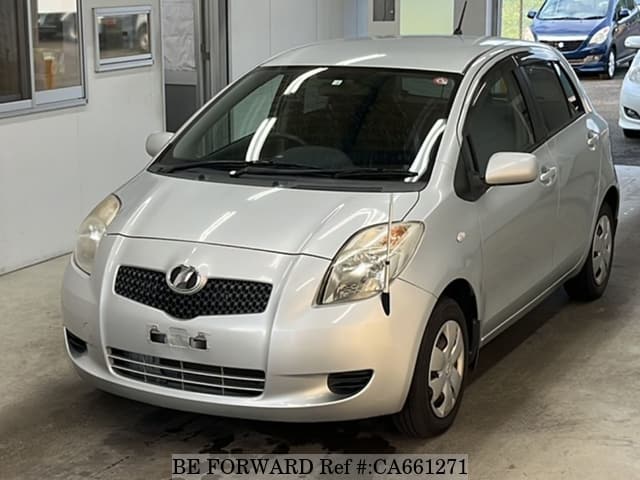 A grey JDM sports car speeding down a highway at night.