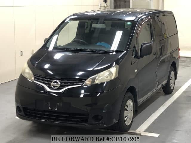 A grey JDM sports car speeding down a highway at night.