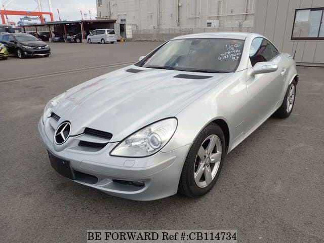 A grey JDM sports car speeding down a highway at night.