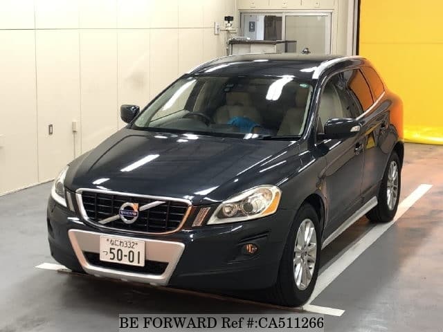 A grey JDM sports car speeding down a highway at night.