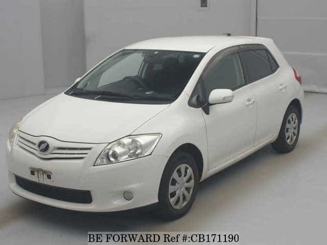 A grey JDM sports car speeding down a highway at night.