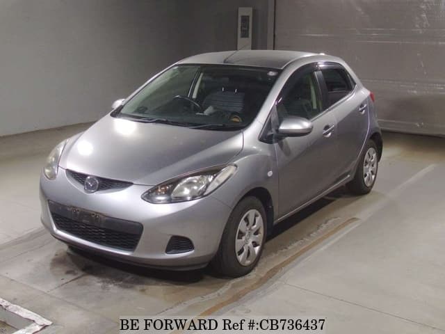 A grey JDM sports car speeding down a highway at night.