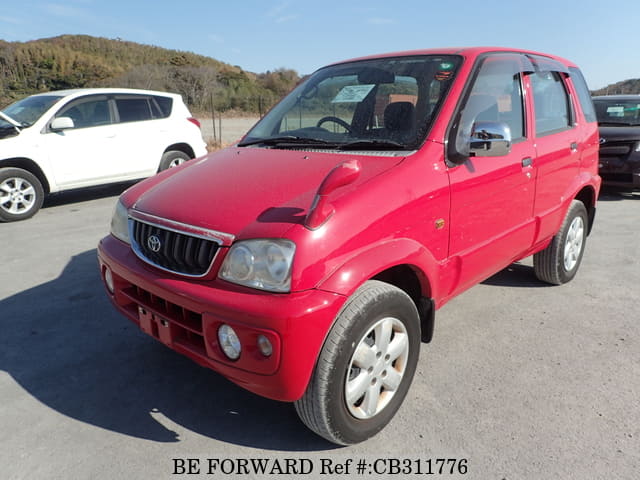 A grey JDM sports car speeding down a highway at night.