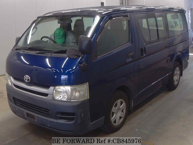 A grey JDM sports car speeding down a highway at night.