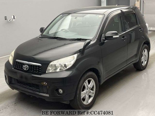 A grey JDM sports car speeding down a highway at night.