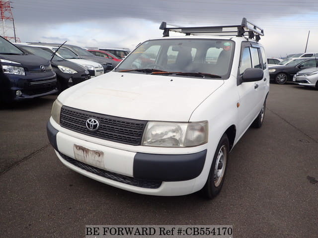 A grey JDM sports car speeding down a highway at night.