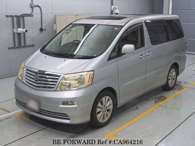 A grey JDM sports car speeding down a highway at night.