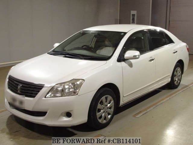 A grey JDM sports car speeding down a highway at night.