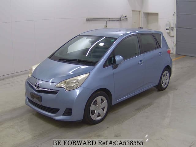 A grey JDM sports car speeding down a highway at night.