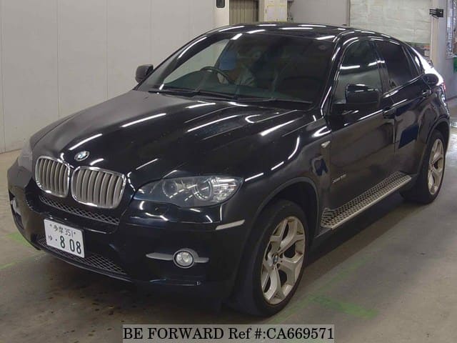 A grey JDM sports car speeding down a highway at night.