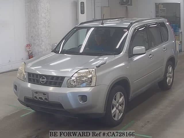 A grey JDM sports car speeding down a highway at night.
