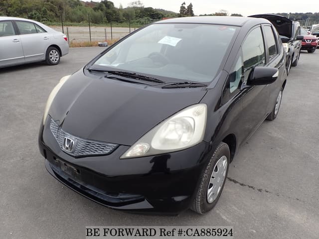 A grey JDM sports car speeding down a highway at night.