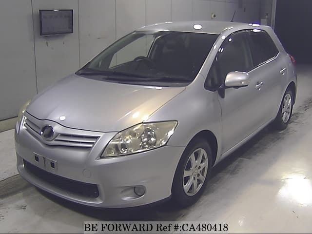 A grey JDM sports car speeding down a highway at night.