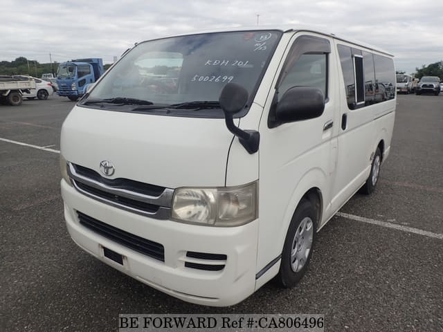 A grey JDM sports car speeding down a highway at night.