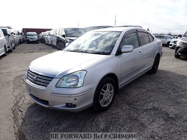 A grey JDM sports car speeding down a highway at night.