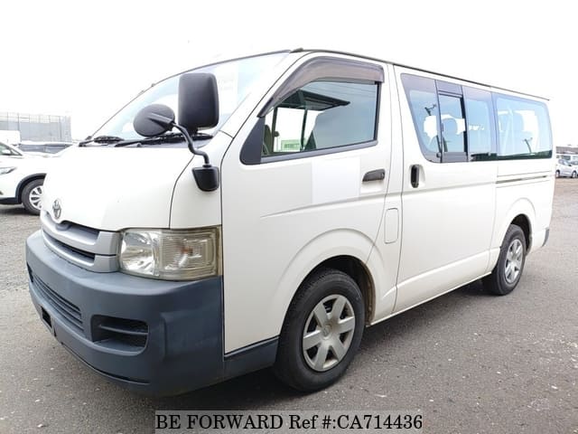 A grey JDM sports car speeding down a highway at night.
