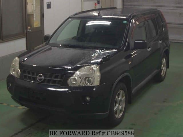 A grey JDM sports car speeding down a highway at night.
