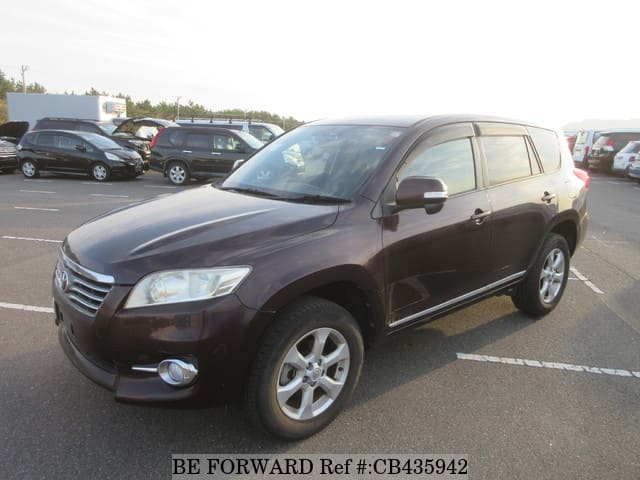 A grey JDM sports car speeding down a highway at night.