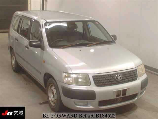 A grey JDM sports car speeding down a highway at night.