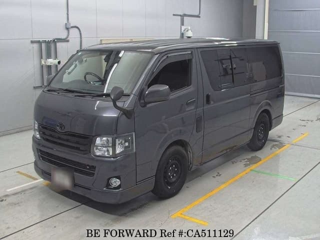 A grey JDM sports car speeding down a highway at night.