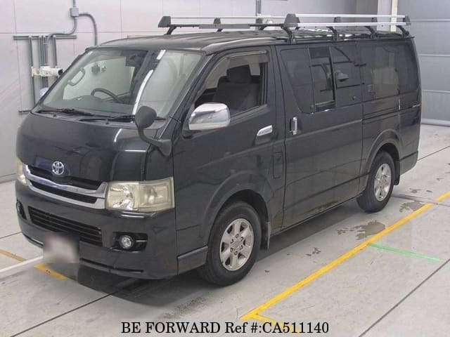 A grey JDM sports car speeding down a highway at night.