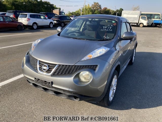 A grey JDM sports car speeding down a highway at night.