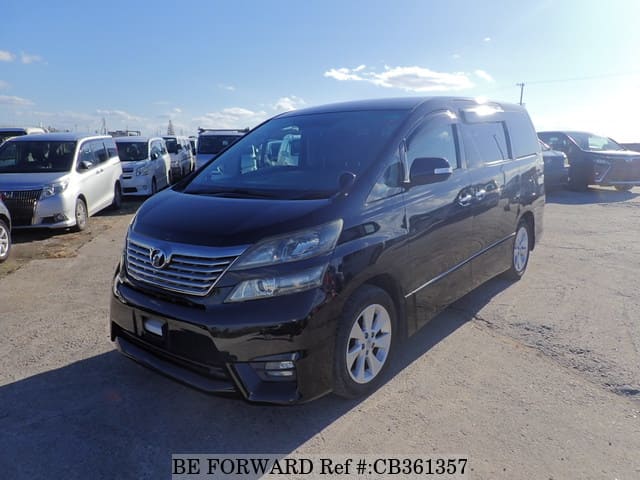 A grey JDM sports car speeding down a highway at night.