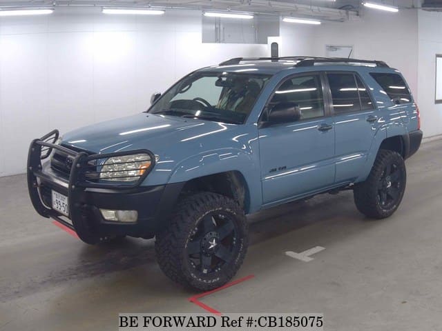 A grey JDM sports car speeding down a highway at night.