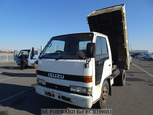 A grey sports car speeding down a highway at night.