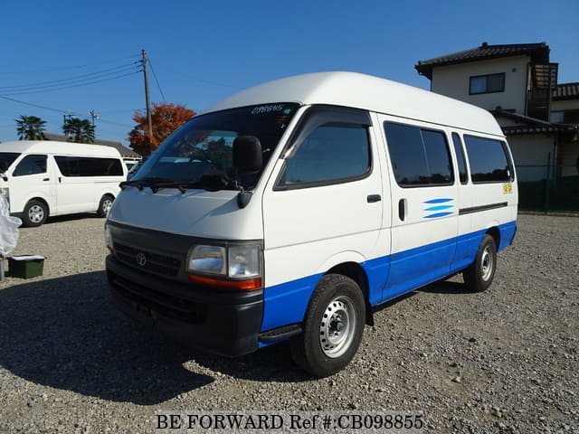 A grey sports car speeding down a highway at night.
