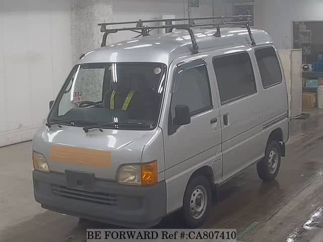 A grey JDM sports car speeding down a highway at night.