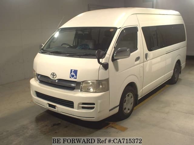 A grey JDM sports car speeding down a highway at night.