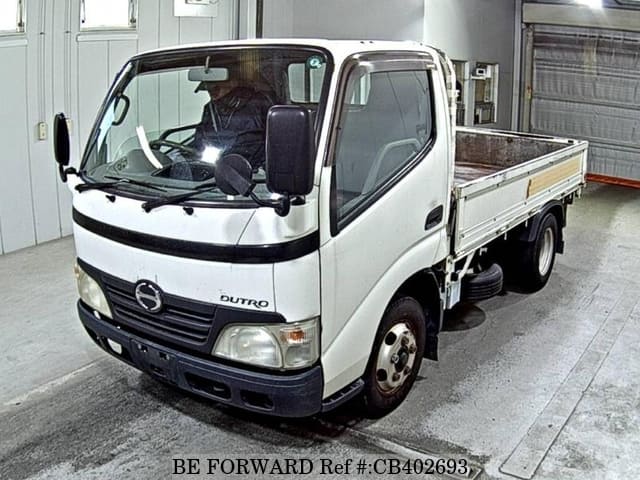 A grey JDM sports car speeding down a highway at night.