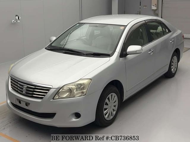 A grey JDM sports car speeding down a highway at night.