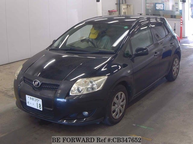 A grey JDM sports car speeding down a highway at night.