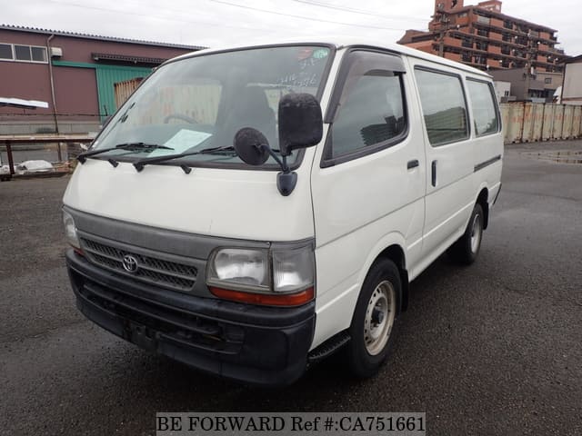 A grey JDM sports car speeding down a highway at night.