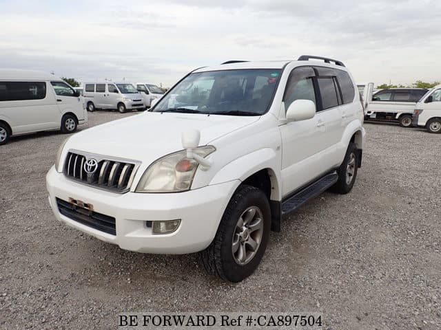 A grey JDM sports car speeding down a highway at night.