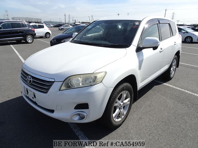 A grey JDM sports car speeding down a highway at night.
