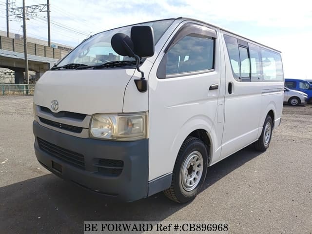 A grey JDM sports car speeding down a highway at night.