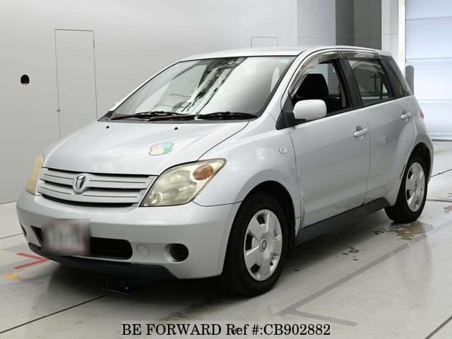 A grey JDM sports car speeding down a highway at night.